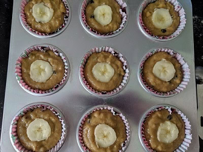 Sliced bananas placed over the muffins for decoration.