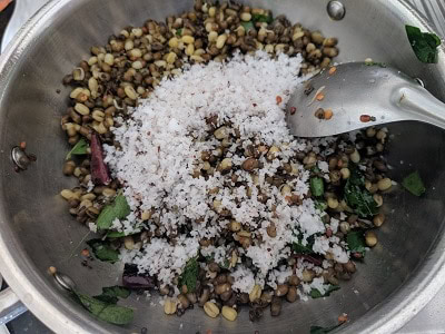 freshly grated coconut added to the sprouts and sundal is ready to serve