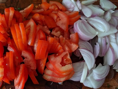 Sliced onions and tomatoes - prep for the kale potato sabzi