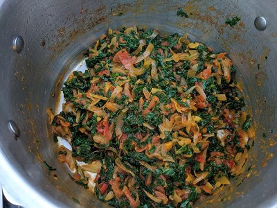 Kale cooking in onion tomato gravy with spices