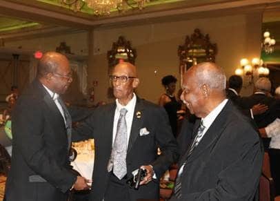 Jamaica’s Minister of Tourism Hon. Edmund Bartlett greets Olympian Byron LaBeach (C) ahead of his award. Sharing the moment is Everald Rhoden.