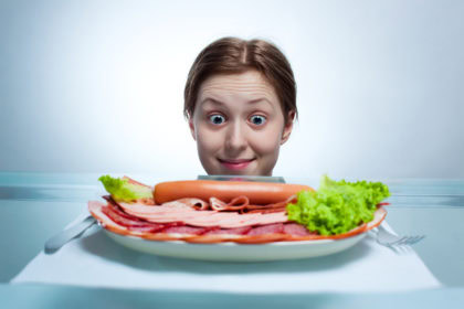 Young woman looking on plate Young woman looking on plate