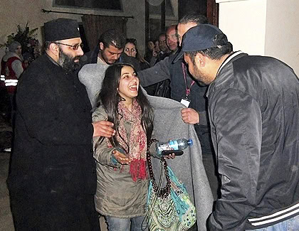 A young Syrian girl evacuated from Homs is warmly welcomed by IOCC/GOPA staff with water and a blanket as she arrives to safety. IOCC/GOPA is assisting in the evacuation of nearly 3,000 people from Homs, which has been under siege for 18 months. photo: IOCC/GOPA