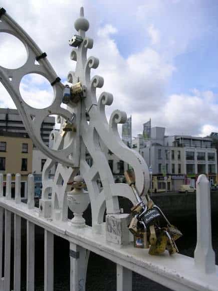 Metal locks attached by couples to the rails of the Ha'penny Bridge in Dublin