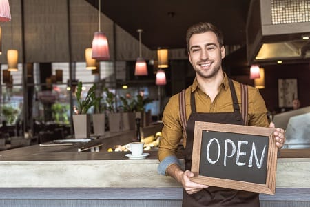 Waiter Holding Open Sign