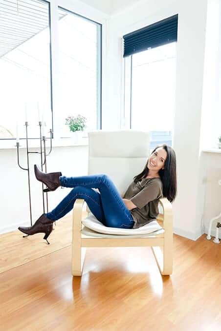 graphic-web-designer-dana-nicole-designs Brunette woman sitting in a chair smiling at the camera