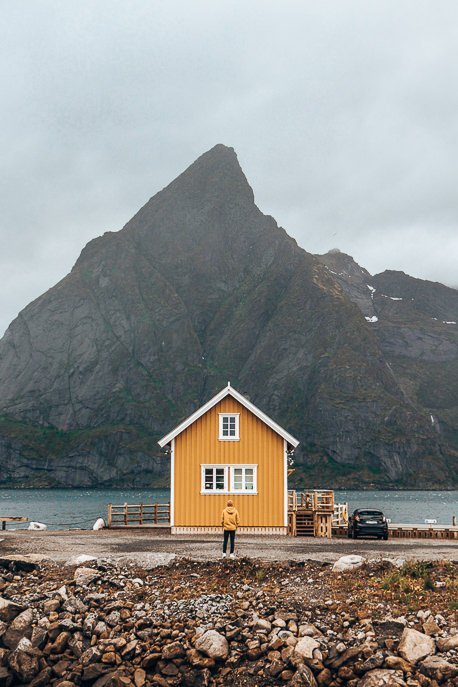 20 Amazing Photos of Norway That Will Leave You Breathless 2 P Bevan matching in his yellow coat with the yellow house in Hamnoy - Lofoten Islands, Norway