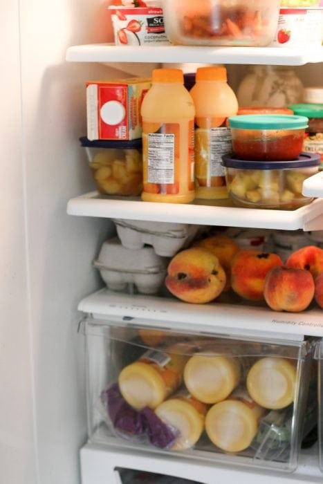 OJ bottles in fridge drawer