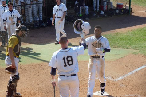 Tre Porter celebrates with #18 Christian Hamel after a home run against West Virginia State