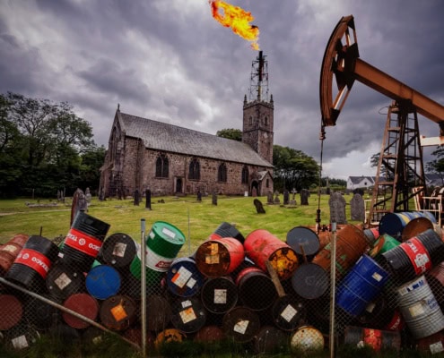 Image of a church with oil barrels and flare