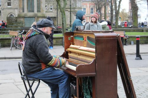man playing piano in park