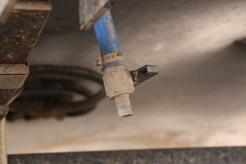 how to empty drain dump fresh water tank in rv trailer camper fifth wheel the camping nerd