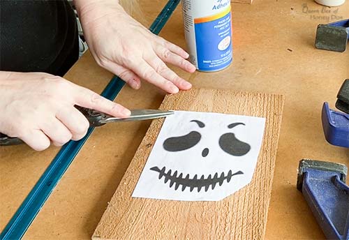 attaching Halloween face pattern to lantern front