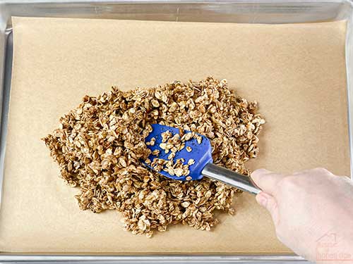 spreading granola in a pan
