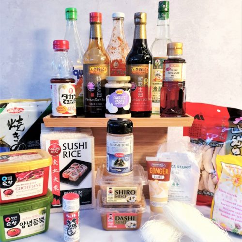 Front on shot of all Asian Ingredients discussed in post. Bottle are raised higher in the background with the other ingredients surrounding them in from.