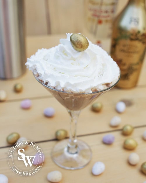 Chocolate Flat White Martini in a cocktail glass decorated with cream and mini eggs