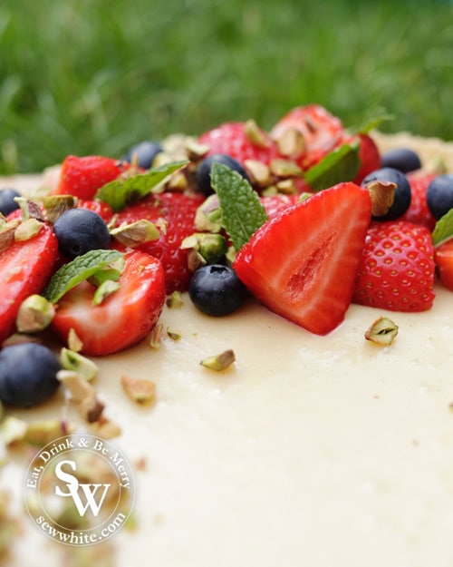 White Chocolate and Ginger Tart with Pistachios topped with fresh strawberries and blueberries