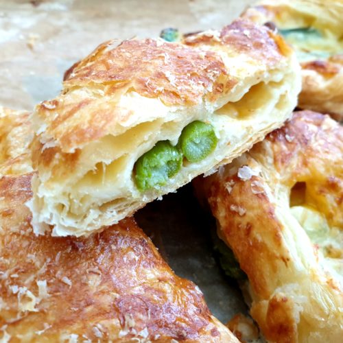 Close up of one puff pastry asparagus wrap cross-section.