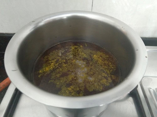 Tamarind simmering with turmeric powder and salt