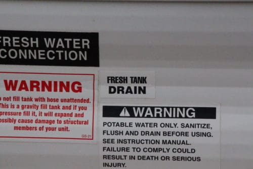 how to empty drain dump fresh water tank in rv trailer camper fifth wheel the camping nerd