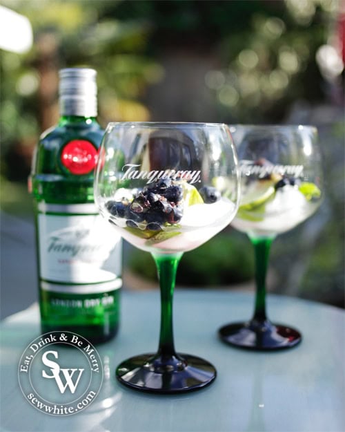 Tanqueray gin glasses and bottle of gin.