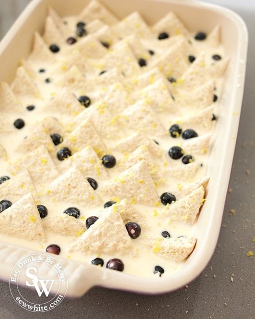 The bread soaking up the custard studded with blueberries and sprinkled with lemon zest.
