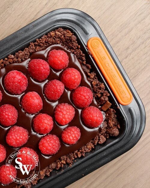 Le Creuset rectangle tart tin filled with a chocolate and raspberry tart