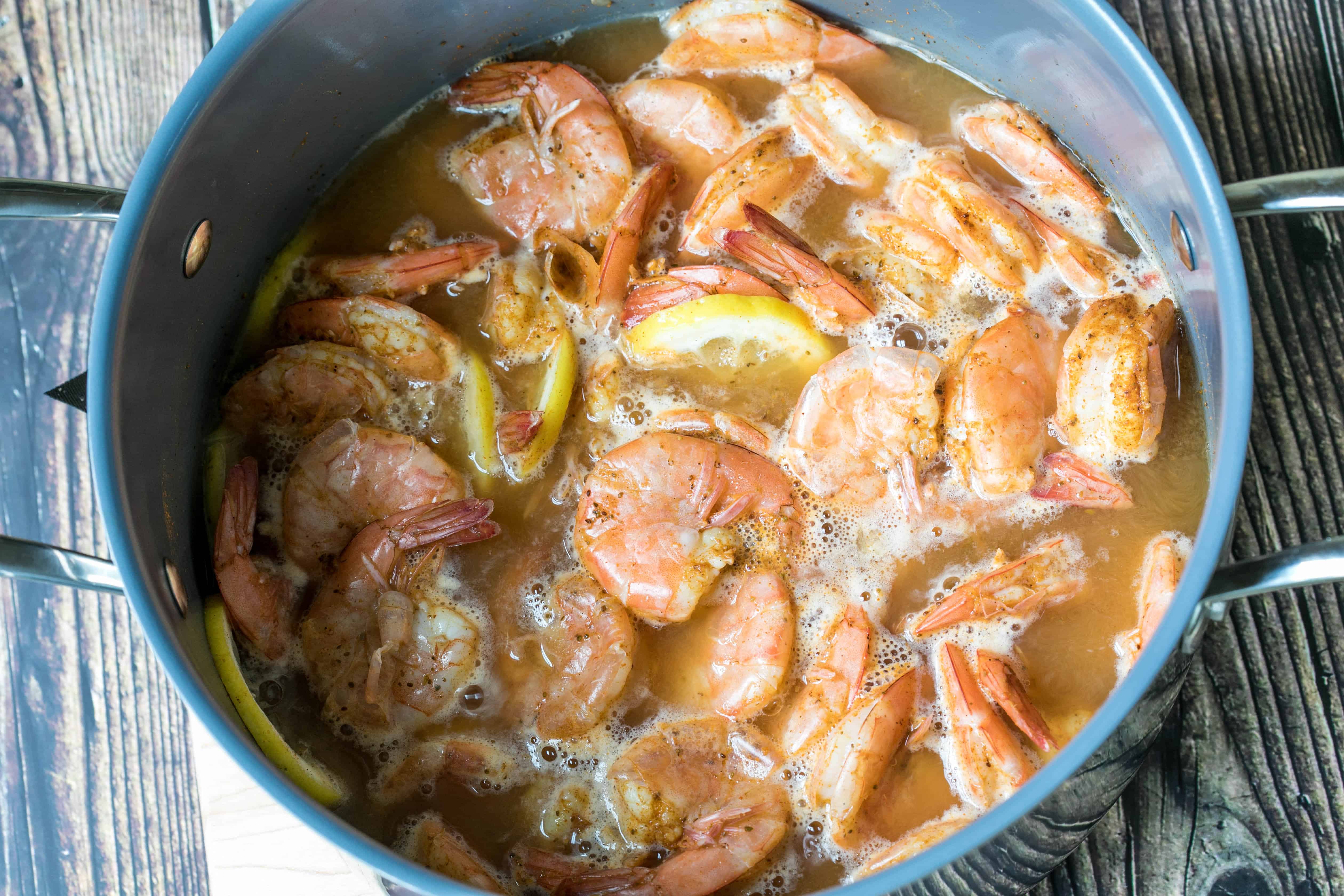 pot of shrimp with lemon, beer, cider vinegar, and old bay