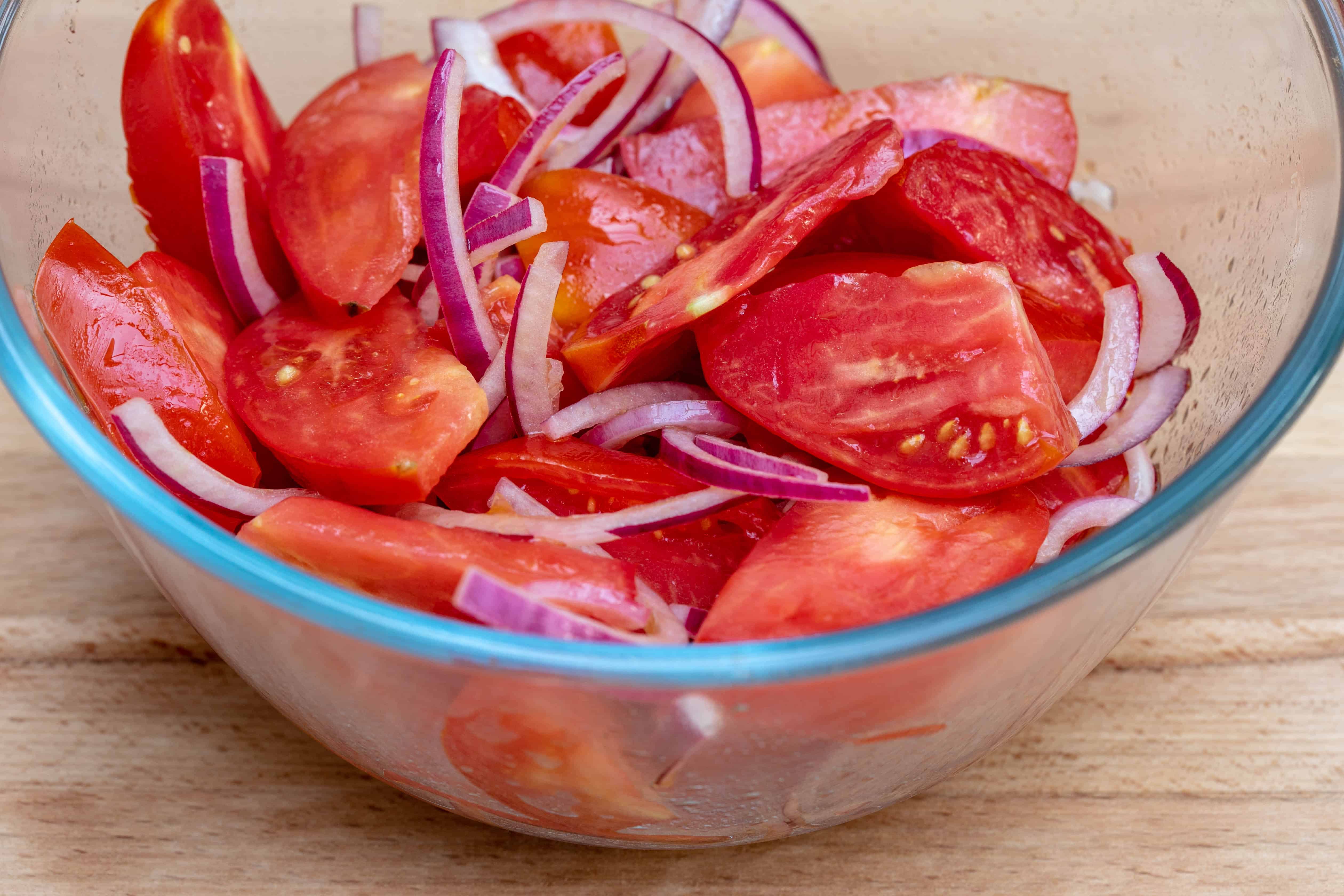 bowl of tomato wedges and red onion slices