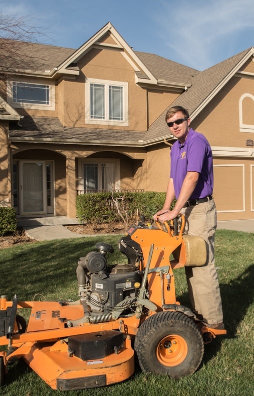 Employee on standing mower
