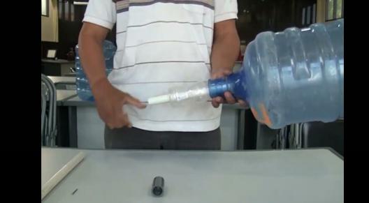 Memasukkan pipa paralon ke dalam galon