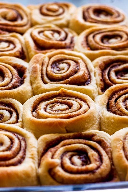 a close view of baked cinnabon cinnamon buns in a baking dish