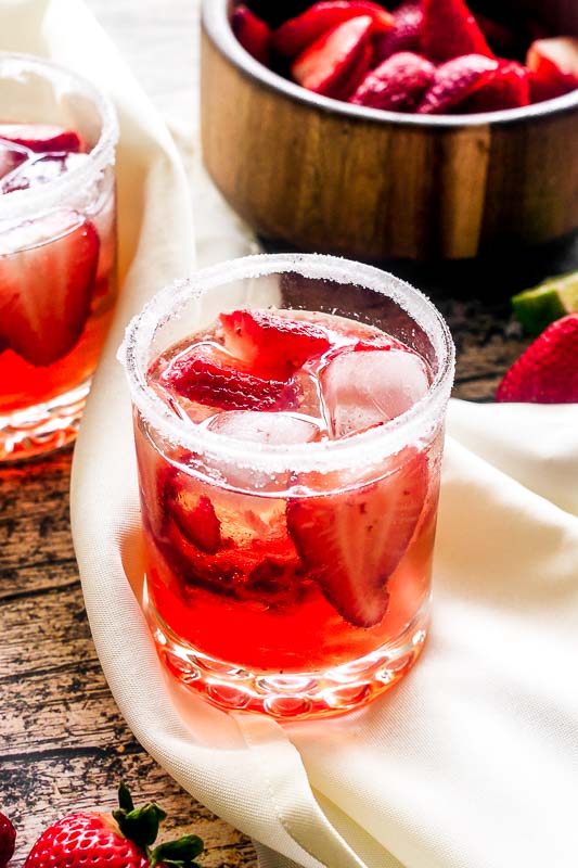 close up of strawberries in a glass of a strawberry cocktail