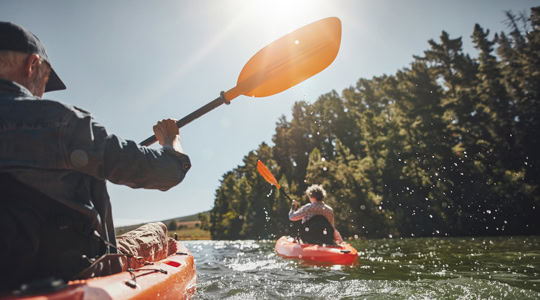 Senior couple kayaking in a lake