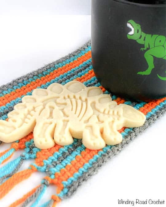 The mug rug is a perfect stocking stuffer next to the cup cozy! But what is a mug rug? It is an oversized coaster big enough for a Mug and a snack! Cookie anyone? This free crochet pattern is quick, easy and great for beginners. Plus if you sign up for my newsletter you get a free printable gift tag to make gifting it that much easier! #mugrug #crochet #free pattern.