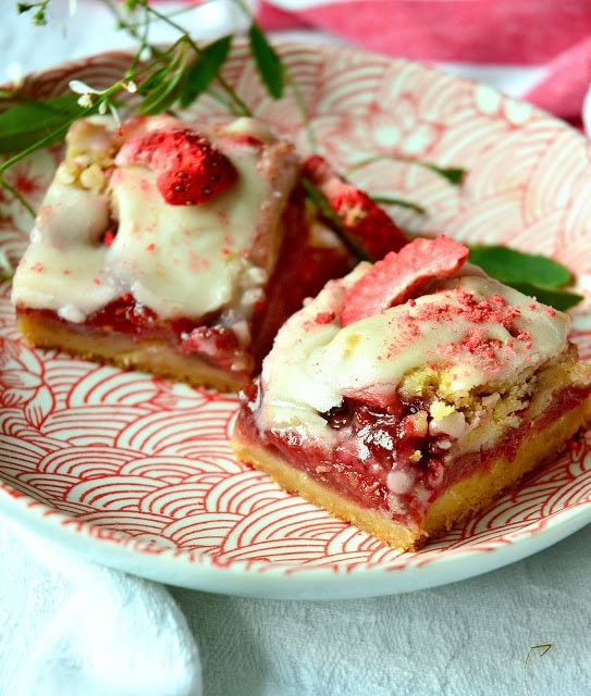 Strawberry Crumble Bars - With a buttery, crisp crust, a delectable fr esh fruit filling, and a crumble of nut filled dough, these red ruby bars are truly phenomenal. Oh, I didn't mention the simple glaze that one drizzles over the top. Yum. Total Yum. Manservant told me to wrap them up and get them out of the house. Not much better compliment, than that, huh? www.thisishowicook.com #cookies #bars #strawberrydesserts