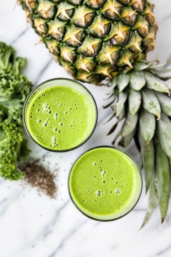 Kale Pineapple Coconut Smoothies next to fresh pineapple