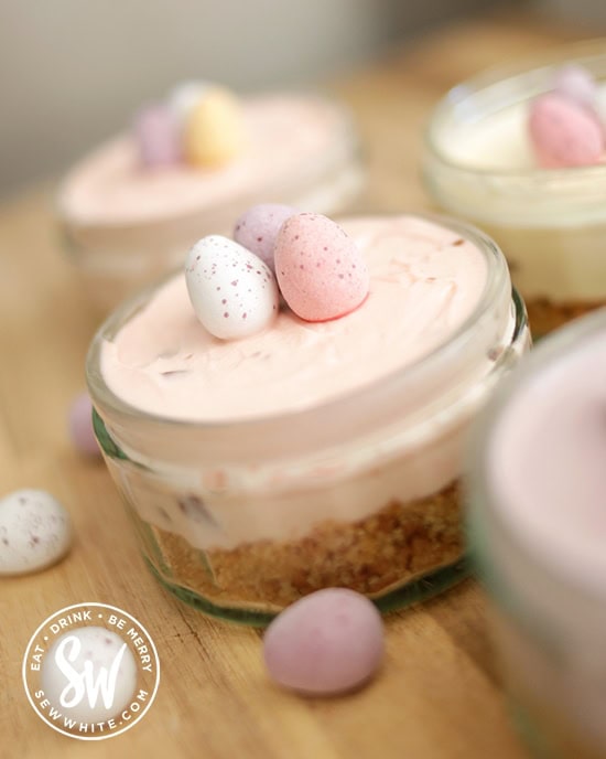 pastel pink cheesecake for Easter studded with mini eggs.