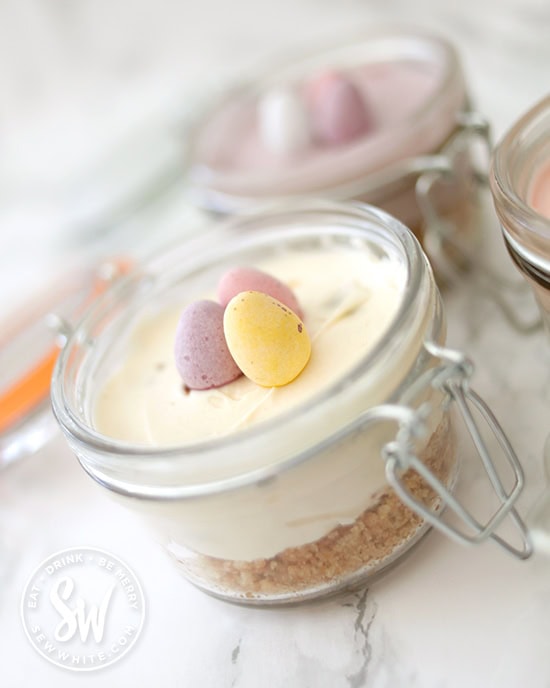 Individual Mini Egg Cheesecakes in clip lock jars ready to be taken on a picnic.