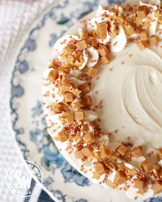 close up of fudge pieces and sprinkles on a no bake cheesecake