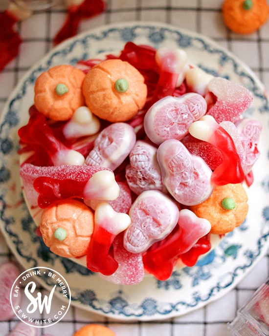 View of the top of the no bake cheesecake covered in Halloween sweets and Halloween Candy