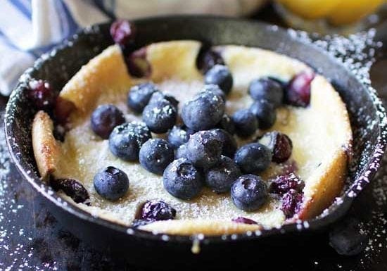 Dutch Baby Pancake with berries on top in mini skillet