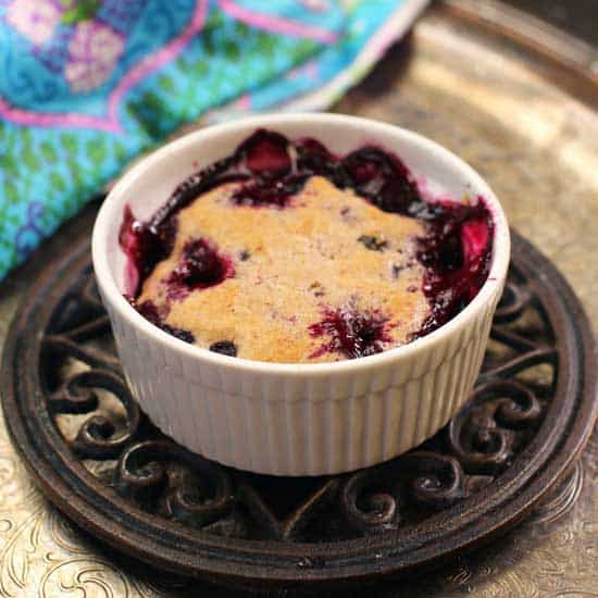 blueberry cobbler in a mini baking dish on a trivet.