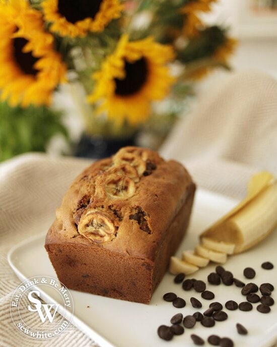 Banana Bread with Chocolate Chips on a plate with sunflowers