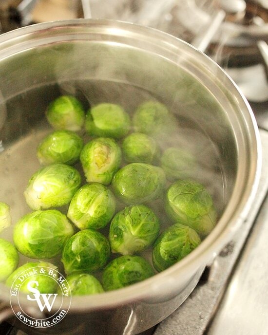 Brussels Sprouts in a silver pan boiling