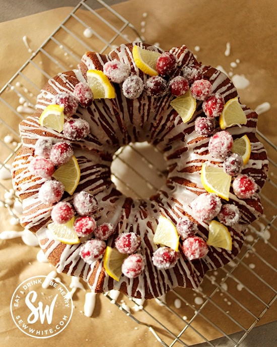 Top view of the Cranberry and Lemon Bundt Cake topped with dusted cranberries and lemon slices