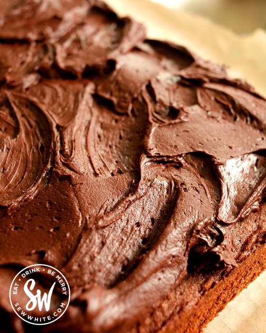 Close up of chocolate cream cheese buttercream on the ultimate chocolate traybake