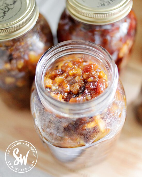 golden mixed fruit in the vegan mincemeat in a glass kilner jars after being cooked in the slow cooker