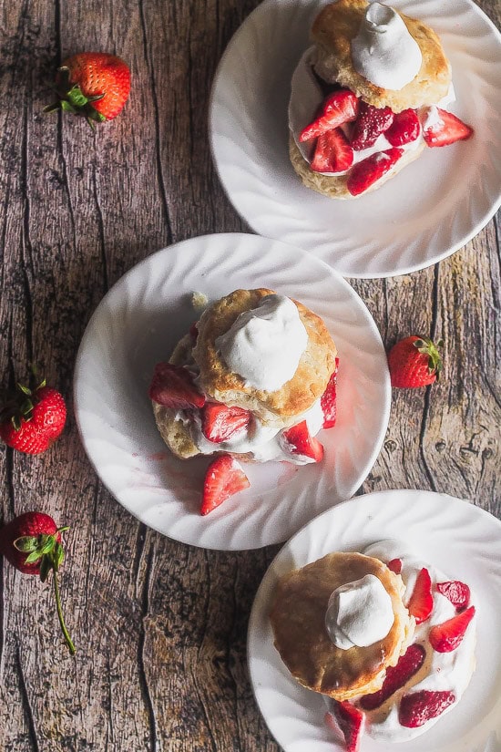 overhead shot of three plates of easy strawberry shortcakes made from scratch