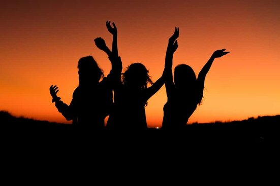 dancing to raise vibration women dancing at sunset